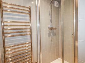A shower with a showerhead and a towel radiator at Beach View House in Newquay