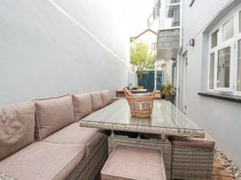 An outdoor seating area with a sofa and a table at Beach View House in Newquay