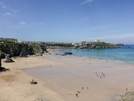 A beach scene with people and water at Beach View House in Newquay