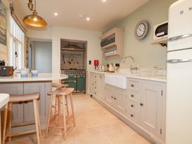 A kitchen with a stove and sink at Beach View House in Newquay