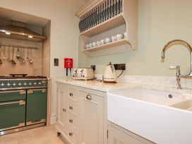 A kitchen with a sink and stove at Beach View House in Newquay