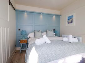 A bedroom with a bed and bedside table at Beach View House in Newquay