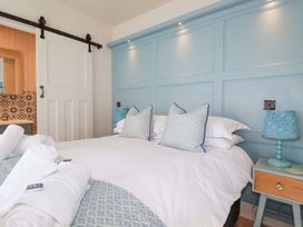 A bedroom with a bed and bedside lamp at Beach View House in Newquay