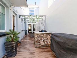 An outdoor area with decking and a grill at Beach View House in Newquay