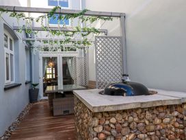 An outdoor patio with a grill and seating area at Beach View House in Newquay