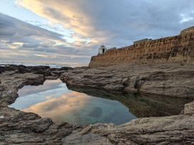 A coastal scene with water and rocks at Fairwinds in Portreath