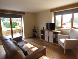 A living room with a sofa and television at The Cartshed in Defford