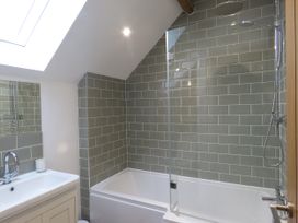 A bathroom with a bathtub and shower at The Cartshed in Defford