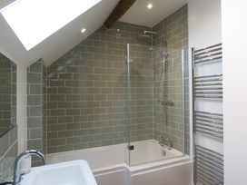 A bathroom with a bathtub and shower at The Cartshed in Defford