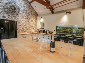 A kitchen with a wooden island and appliances at St Dogwells Barn near Wolfscastle