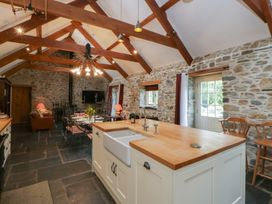 A kitchen with an island and sink at St Dogwells Barn near Wolfscastle