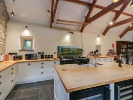 A kitchen with a central island and various appliances at St Dogwells Barn near Wolfscastle
