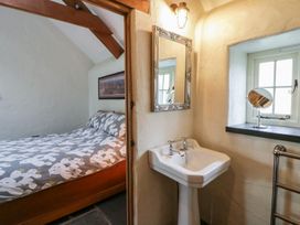 A bedroom with a bed and a sink at St Dogwells Barn near Wolfscastle