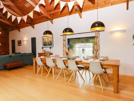 A dining room with a table and chairs at Halshanger Barn in Newton Abbot