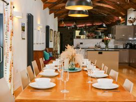 A dining room with a large table set for meals at Halshanger Barn Newton Abbot