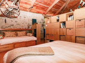 A bedroom with a bed and bookshelf at Halshanger Barn in Newton Abbot