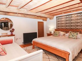 A bedroom with a large bed and furniture at Halshanger Barn in Newton Abbot