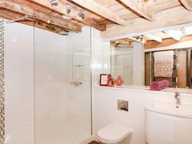 A bathroom with a shower, sink, and toilet at Halshanger Barn in Newton Abbot