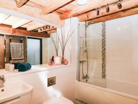 A bathroom with a bathtub, toilet, sink, and shower at Halshanger Barn in Newton Abbot
