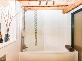 A bathroom with a bathtub and shower at Halshanger Barn in Newton Abbot