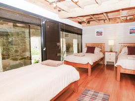 A bedroom with two beds and a nightstand at Halshanger Barn Newton Abbot