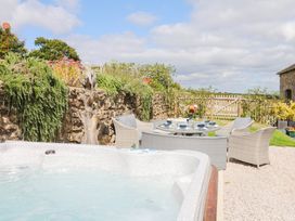 A garden featuring a hot tub and seating area at Halshanger Barn Newton Abbot