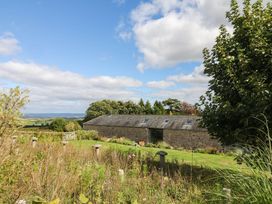 A barn with trees and grass at Halshanger Barn in Newton Abbot