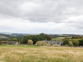 A view of fields and farmhouses at Halshanger Barn in Newton Abbot