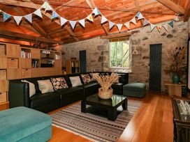 A living room with a sofa and coffee table at Halshanger Barn near Ashburton