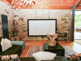 A snug with a screen and seating at Halshanger Barn near Ashburton