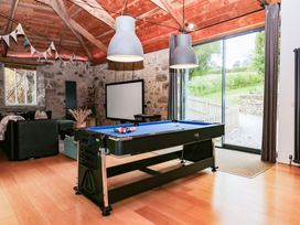 A snug room with a pool table and a television at Halshanger Barn near Ashburton