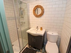 A bathroom with a shower cubicle sink with cabinet mirror and toilet at Seahaven in Allonby