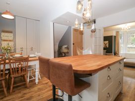 A kitchen with an island and dining table at The Wonky Nest in Bowness-On-Windermere