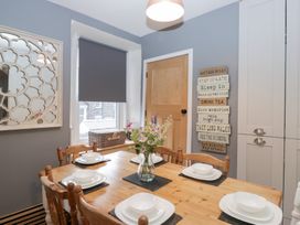 A dining room with a table set for meal at The Wonky Nest in Bowness-On-Windermere