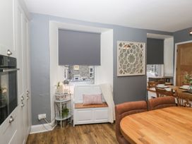 A kitchen with a dining area and bench seating at The Wonky Nest in Bowness-On-Windermere