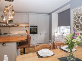 A kitchen with table and chairs at The Wonky Nest in Bowness-On-Windermere