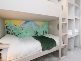 A bunk bed with a mural and towels at The Wonky Nest in Bowness-On-Windermere