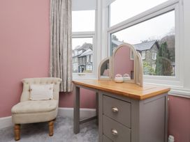 A bedroom with a vanity table and chair at The Wonky Nest in Bowness-On-Windermere
