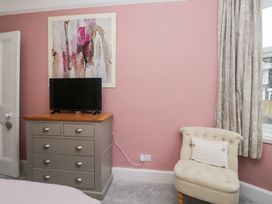 A bedroom with a dresser and television at The Wonky Nest in Bowness-On-Windermere