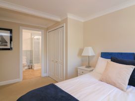 A bedroom with a bed and an adjoining bathroom at 6 Dartmouth House in Dartmouth