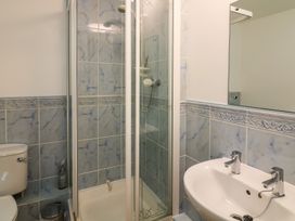 A bathroom with a shower, sink, and toilet at 6 Dartmouth House in Dartmouth