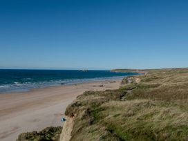 A beach with cliffs and ocean at Chalet 3 Wipeout in Hayle