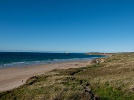 A beach with sand and grass in Hayle