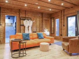 A living room with a sofa and coffee table at Bee Hive South Luffenham near Edith Weston