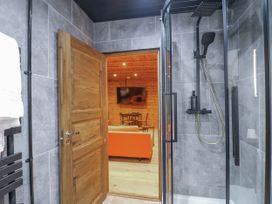 A shower and door leading to a living room at Bee Hive in South Luffenham near Edith Weston