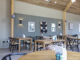 A dining area with tables and chairs at Bee Hive in South Luffenham near Edith Weston