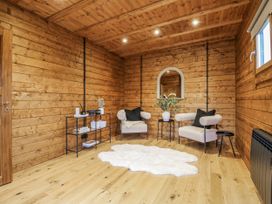 A snug with wooden walls and two chairs at Bee Hive South Luffenham near Edith Weston