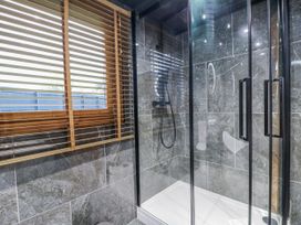 A bathroom with a shower and tiles at Rabbit Hole near Stamford