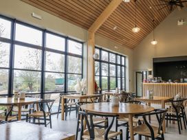 A café with wooden tables and chairs at Rabbit Hole near Stamford
