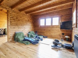 A living room with a sofa and television at Rabbit Hole near Stamford